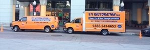Water and Mold Damage Restoration Vehicles At Job Site